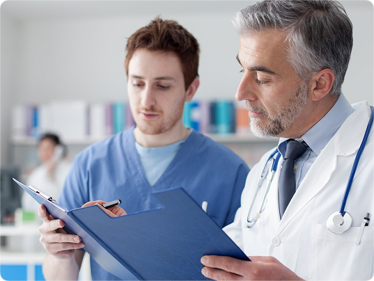 Clinicians reviewing neurological assessment notes.